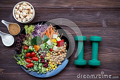 Diet Healthy food and lifestyle health concept. Sport exercise equipment workoutÂ andÂ gym background with nutrition detox salad f Stock Photo